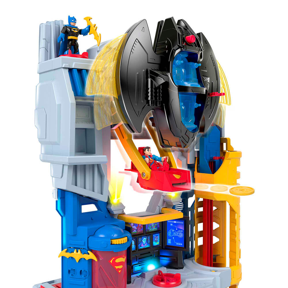 Side view of the Imaginext DC Super Friends Ultimate Headquarters Hall of Justice Playset with superman sitting in seat shooting out coins