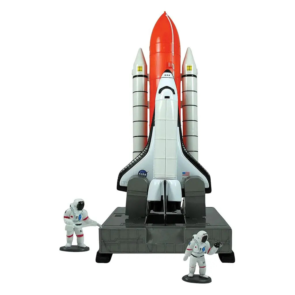 InAir space shuttle playset shows the shuttle on a grey launch platform with two astronaut figures standing nearby, highlighting molded plastic boosters, cockpit shape, and upright rocket form for creative space exploration. Designed to emphasize molded details and child-friendly imaginative play.