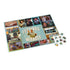 Seinfeld Festivus jigsaw puzzle with teal and multicolor printed cardboard surface, flat rectangular layout, featuring sitcom scene collage and central character graphic, partially assembled with loose pieces on a clean white background.