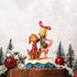 Jim Shore figurine of Cindy Lou Who and Max displayed in a holiday scene with snow, trees, and ornaments, standing on a festive log base.