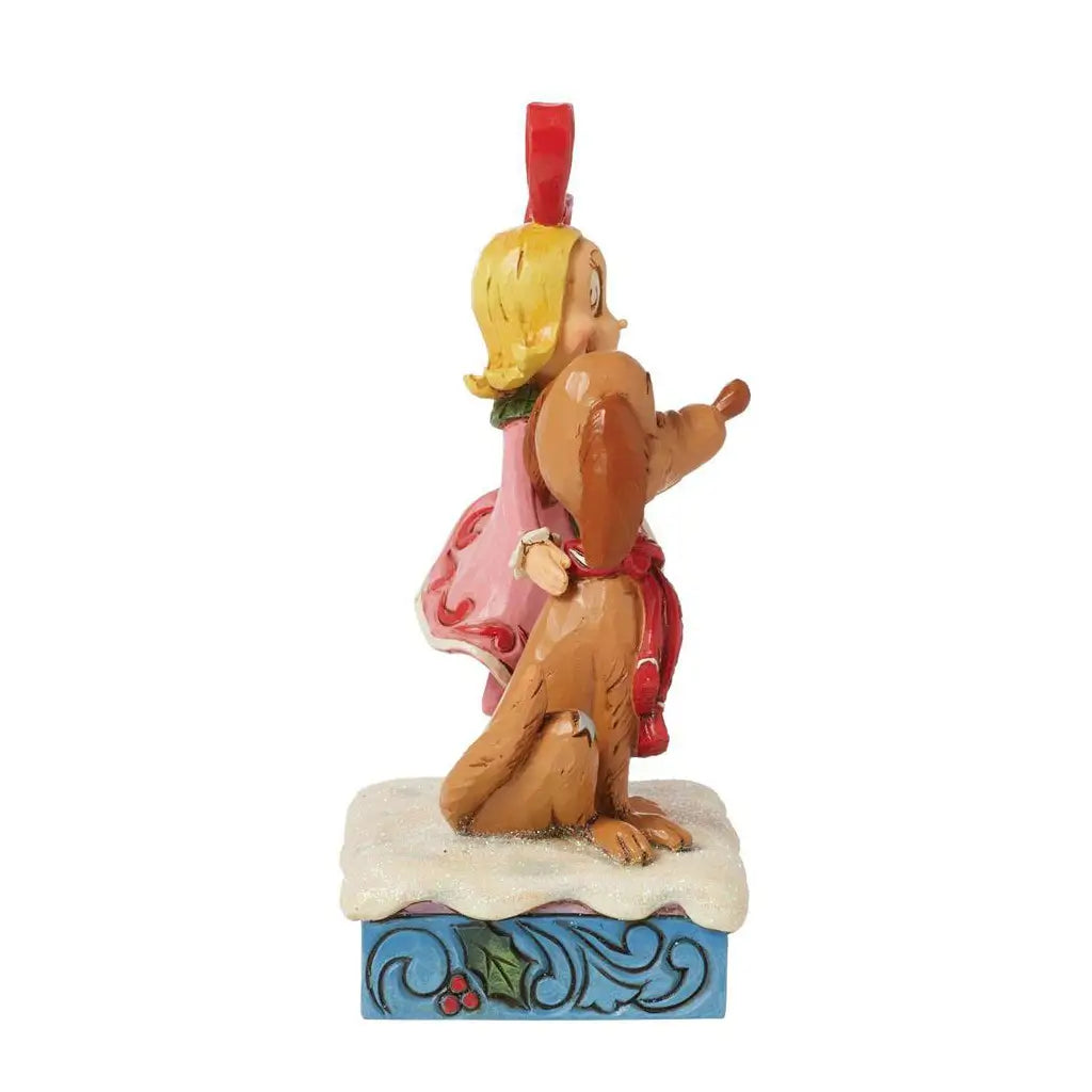 Side view of Jim Shore figurine featuring Cindy Lou Who and Max the dog standing on snowy base with holiday designs, both wearing festive attire.