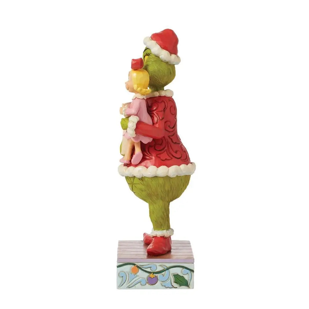 Alternate side view of Grinch figurine by Jim Shore holding Cindy Lou Who in pink dress, with intricate sculpting and hand-painted holiday detailing.