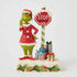 Jim Shore Grinch LED figurine with stop sign light turned off, showing detailed holiday scene with Grinch and colorfully wrapped presents.