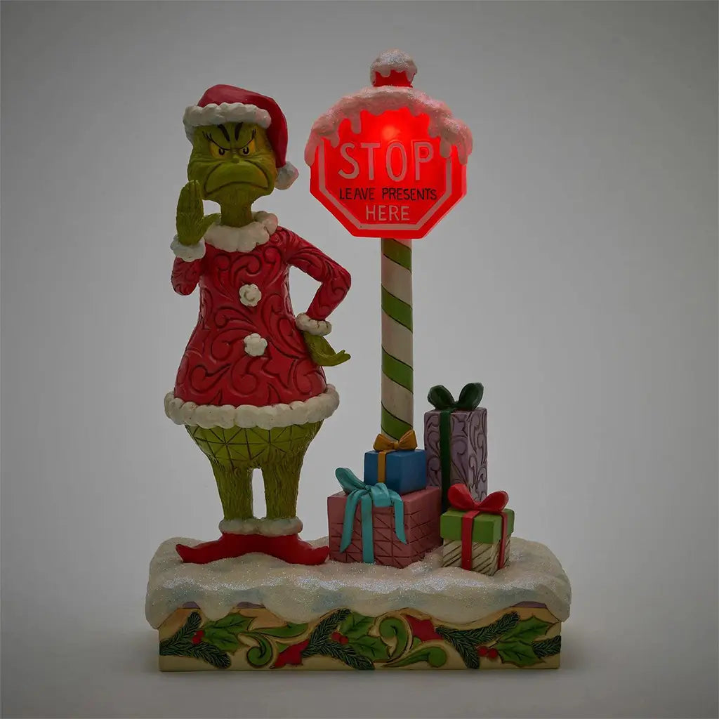 Front view of Jim Shore Grinch LED figurine with glowing red stop sign reading 