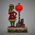 Front view of Jim Shore Grinch LED figurine with glowing red stop sign reading "STOP LEAVE PRESENTS HERE" beside stacked gifts on snowy base.