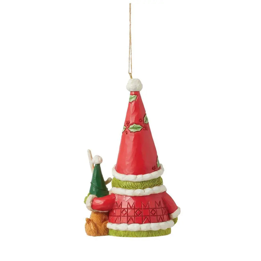 Rear view of Jim Shore Grinch gnome ornament featuring a tall red Santa hat with holly accents, standing beside Max the dog wearing a green holiday hat.