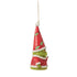 Side view of Jim Shore Grinch gnome ornament with tall red hat and green mittens, showing detailed textures and holding a red heart, standing beside Max.