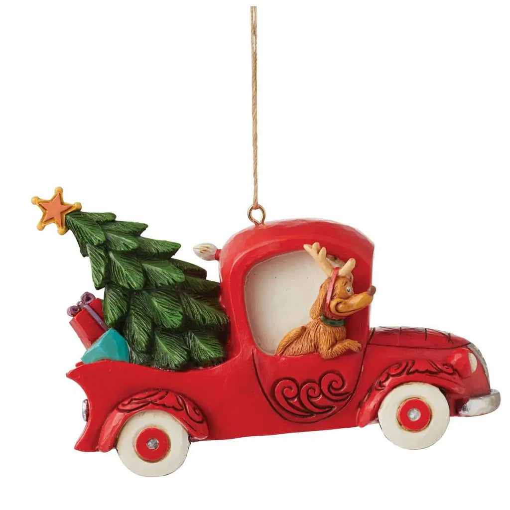 Alternate side view of Jim Shore ornament with Grinch at the wheel and Cindy Lou Who among presents and a holiday tree in a red vintage truck.