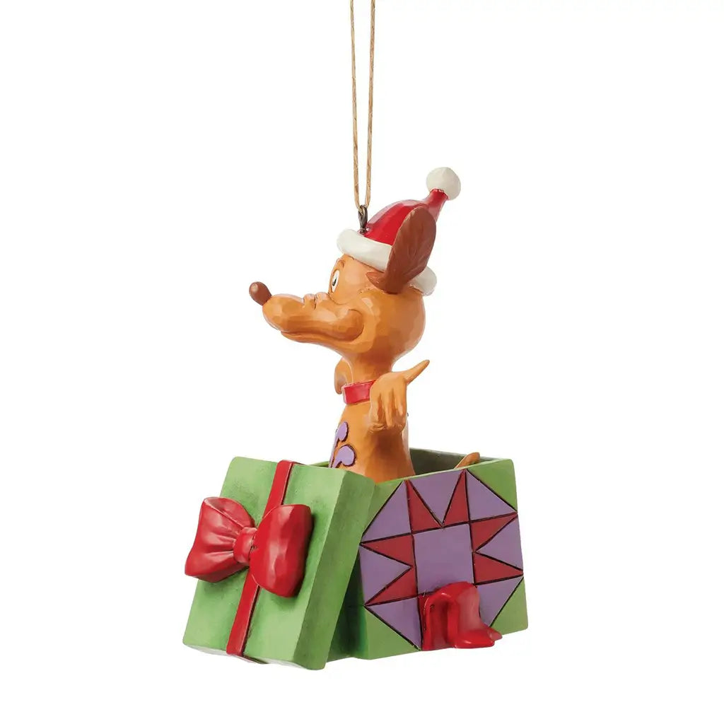 Alternate side view of Jim Shore Max figurine as he pops out of a gift box wearing a Santa hat, with geometric patterns and ribbon detailing on the box.