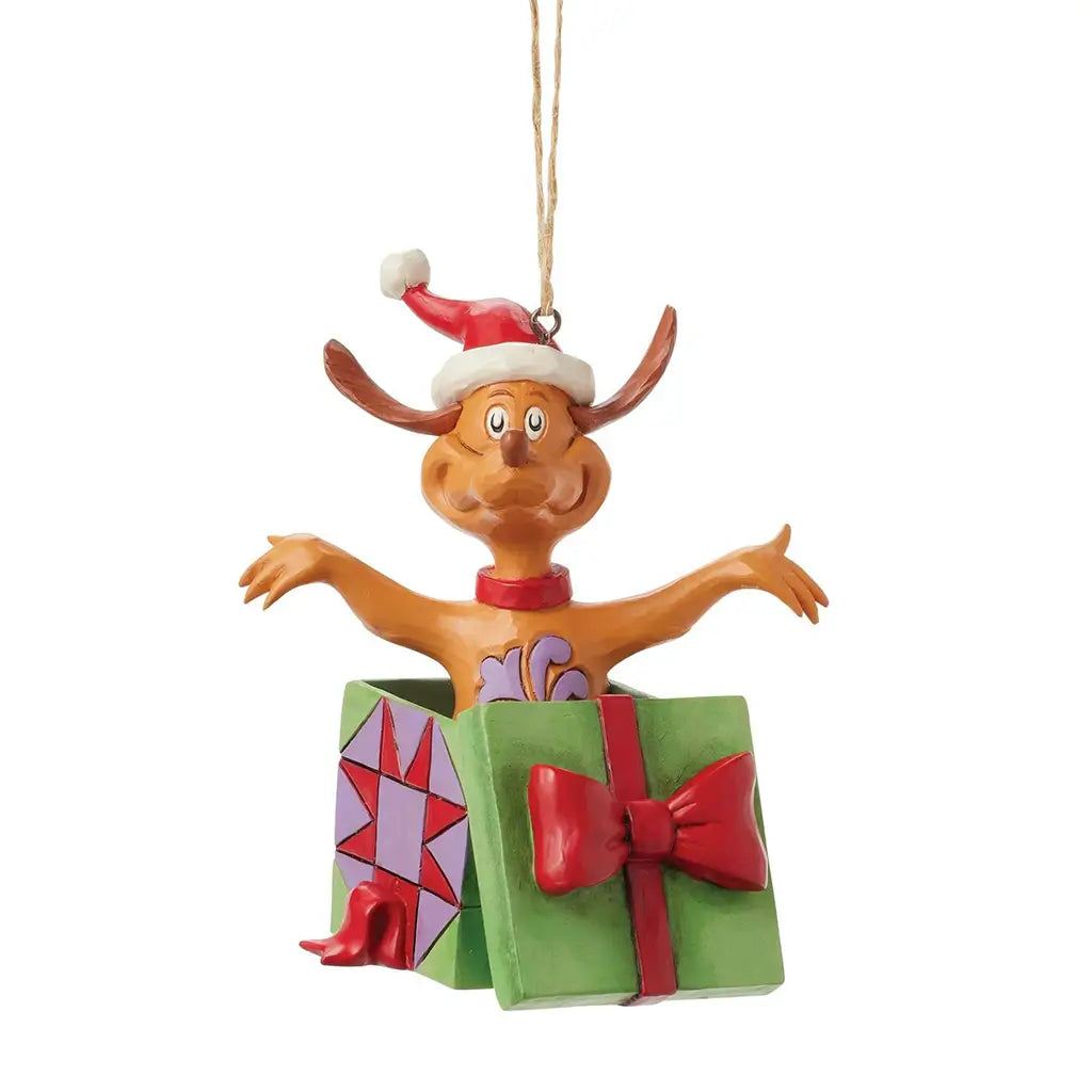 Front view of Jim Shore Max Christmas ornament featuring Max in a Santa hat, arms open wide, emerging from a decorated green and purple gift box.