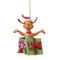 Front view of Jim Shore Max Christmas ornament featuring Max in a Santa hat, arms open wide, emerging from a decorated green and purple gift box.