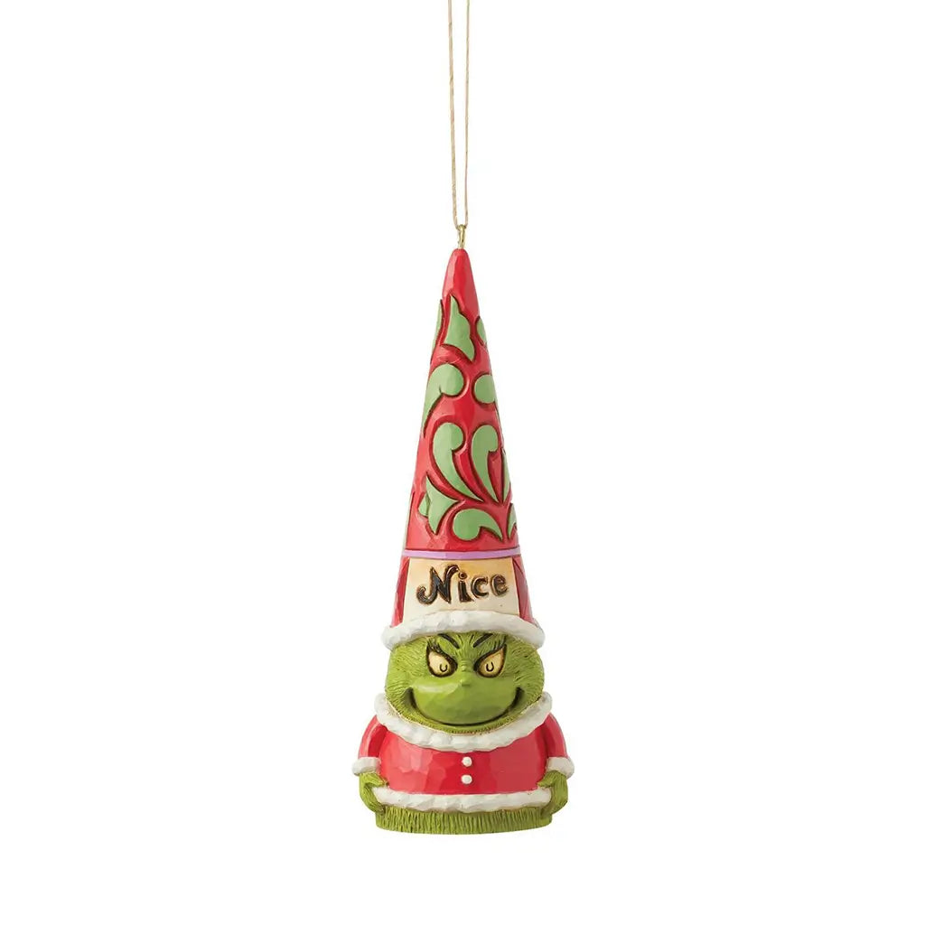 Front view of Jim Shore Grinch gnome ornament with smiling face and “Nice” label on red and green hat, dressed in red Santa outfit with white trim.
