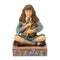 Front view of Hermione Granger Jim Shore collectible figurine, hand-painted with detailed Gryffindor tie, cross-legged pose, decorative base with owls and stained glass motifs.