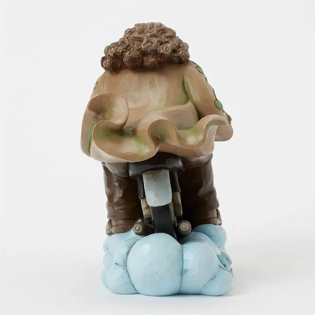 Rear view of Jim Shore Hagrid motorbike figurine emphasizes sculpted curls, outstretched coat, and intricate motorbike tail section riding on cloud base.