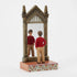 Angled figurine of Harry Potter by Jim Shore depicts Harry staring into Mirror of Erised, framed with intricate gold details and gothic-style pointed top.
