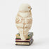 Left side of Jim Shore Hedwig mini figurine shows owl holding Hogwarts letter, intricate feather details, and stacked sculpted books with gilded patterns.