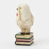 Jim Shore Harry Potter Hedwig mini figurine shows white snowy owl holding Hogwarts acceptance letter, perched on stacked books with ornate carved detail.