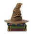 Jim Shore Harry Potter Sorting Hat mini figurine shows wrinkled brown hat with carved details, resting atop colorful stacked books in green, blue, and purple.