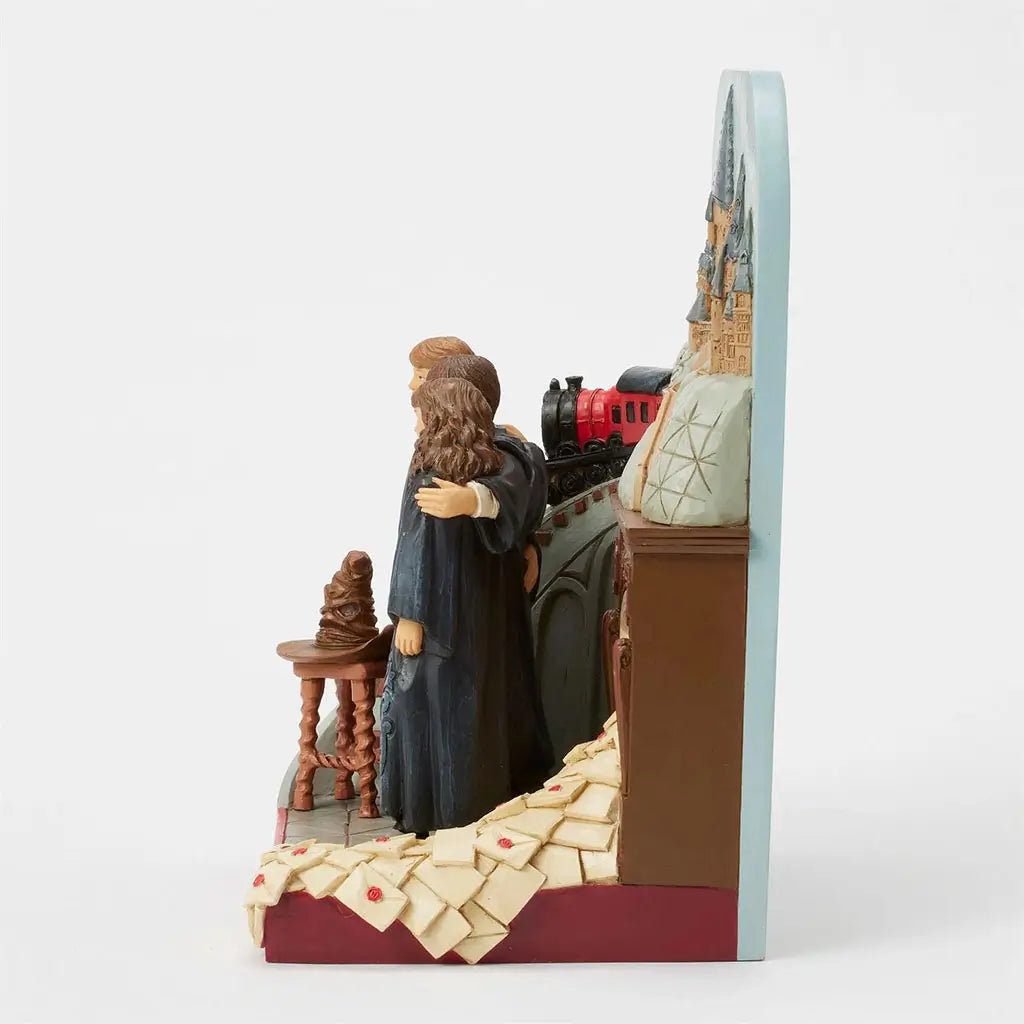 Right angled view of Harry Potter Jim Shore figurine featuring castle backdrop, Hogwarts Express, Gryffindor trio, Sorting Hat, fireplace, and overflowing letters.