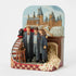 Right angled view of Harry Potter Jim Shore figurine featuring castle backdrop, Hogwarts Express, Gryffindor trio, Sorting Hat, fireplace, and overflowing letters.