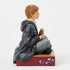 Left side view of Jim Shore Ron Weasley figurine, painted in Hogwarts robes with hand-carved texture, showing Scabbers the rat resting in his hands.
