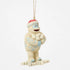 Angled view of Jim Shore Bumble holiday ornament, showing white textured fur, blue carved designs, and cheerful snowball pose.