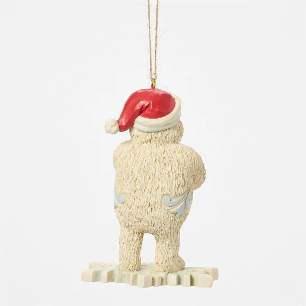 Back view of Jim Shore Bumble ornament from Rudolph the Red-Nosed Reindeer, with textured fur detail, Santa hat, and snowflake-shaped base.