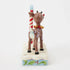 Rear angled view of Jim Shore Rudolph countdown figurine, showing reindeer with gold bell collar and red nose beside striped holiday calendar frame.