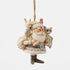 Angled front view of cream Jim Shore Santa ornament with brown boots, patterned coat, woodland animals in arms, and red bird perched on hat, carrying sack over shoulder.