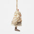 Side view of cream and brown Jim Shore Santa figurine holding woodland animals, including bunny and raccoon, with red bird on hat, carrying sack over shoulder.