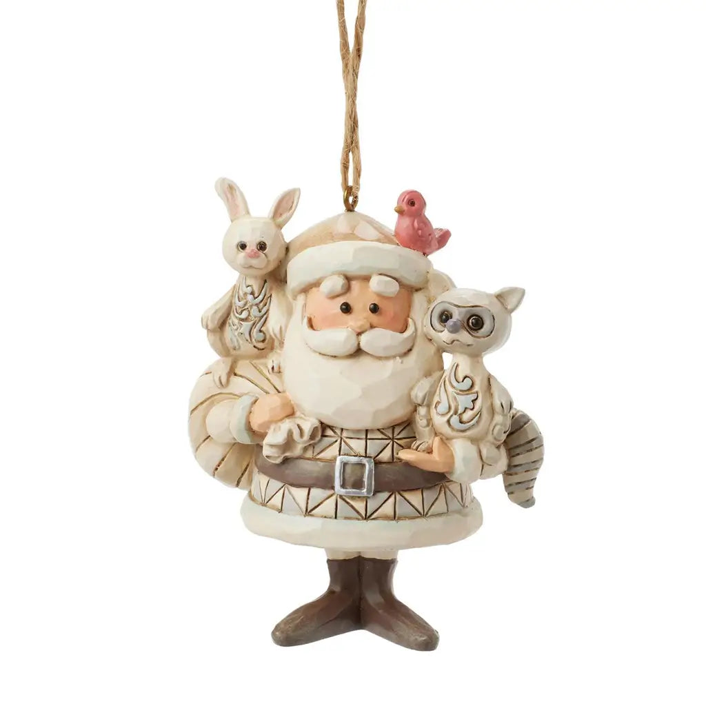 Front view of Jim Shore cream Santa ornament with geometric patterned coat, holding bunny and raccoon, red bird on hat, sack on back, set against plain white background.