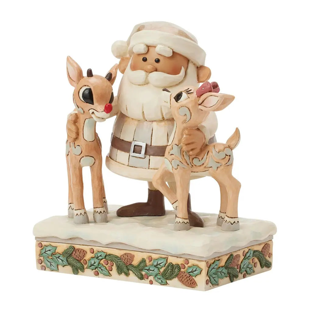 Angled front view of Jim Shore cream Santa figurine holding reindeer, including red-nosed Rudolph, on snowy holly-trimmed base, against plain white background.