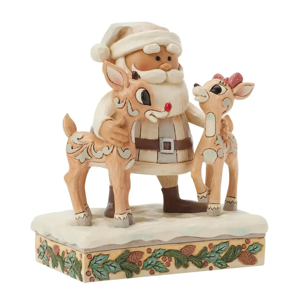 Angled view of Jim Shore cream and brown Santa figurine holding two reindeer, one with red bow, on snowy base with pinecone and holly design, against white background.