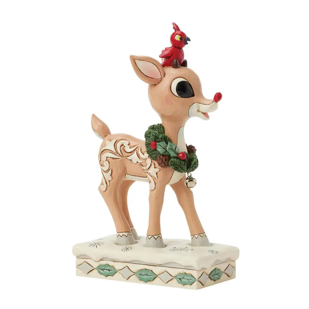 Christmas-themed reindeer figurine with a cardinal on its head, wearing a wreath, on a white background.