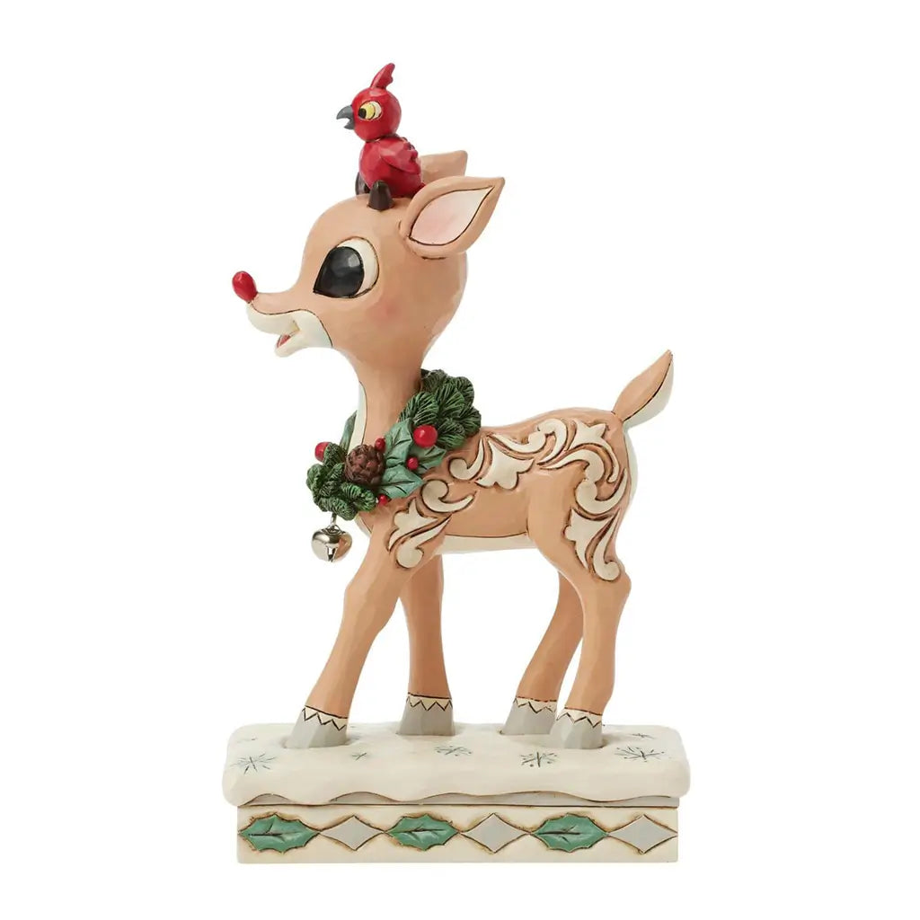 Deer figurine with a cardinal bird on its head and holly wreath, on a white background.