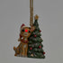 Jim Shore woodland Rudolph ornament with light-up red nose, wearing Santa hat beside decorated Christmas tree.