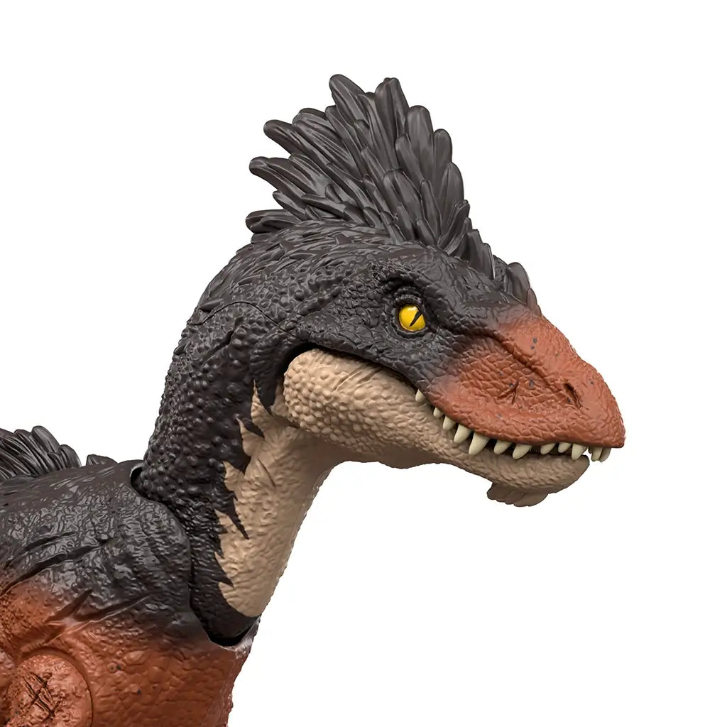 Jurassic World Achillobator close-up featuring a dark gray feathered head, orange-brown snout, sharp sculpted teeth, and yellow eye, highlighting detailed facial sculpting and realistic predator styling on a white background.