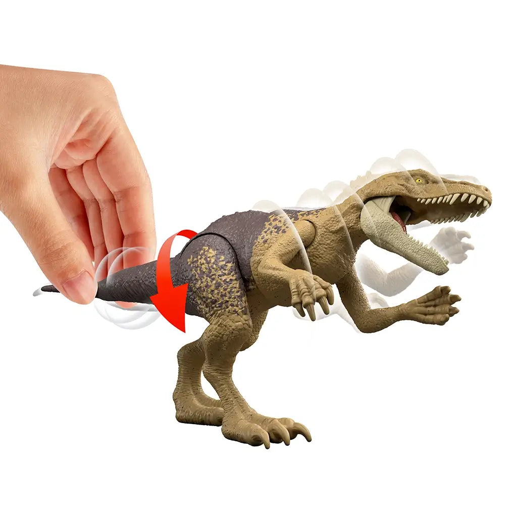 Jurassic World Herrerasaurus Strike Attack feature demonstrated as a hand moves the tail, triggering head and jaw snapping motion to showcase articulated action play, photographed on a white studio background.