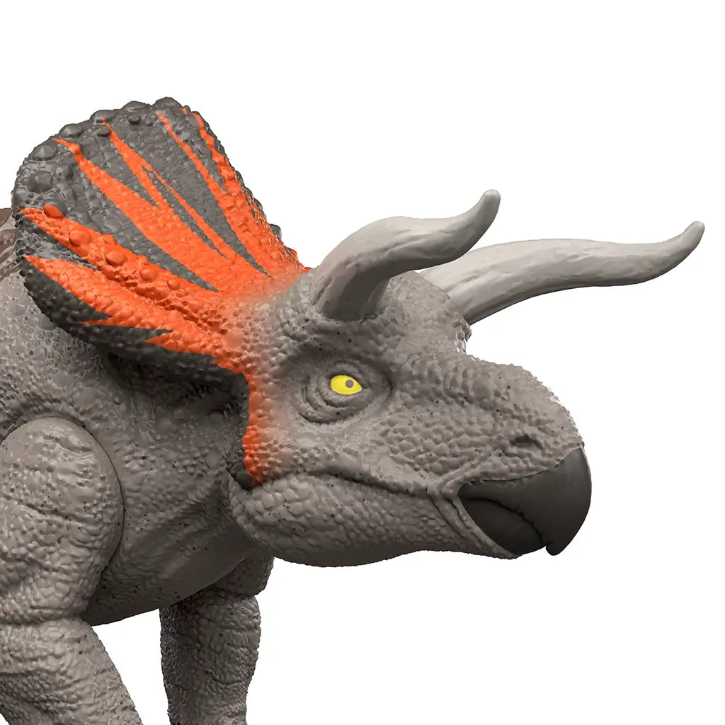 Jurassic World Zuniceratops close-up featuring gray textured plastic skin, curved white horns, orange-accented frill, and bright yellow eye, emphasizing detailed sculpting and realistic toy design on a white background.