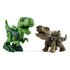 Two assembled toy dinosaurs, a green T-Rex and a tan Stegosaurus, stand facing each other with open mouths and screw-connected limbs on a plain white surface.
