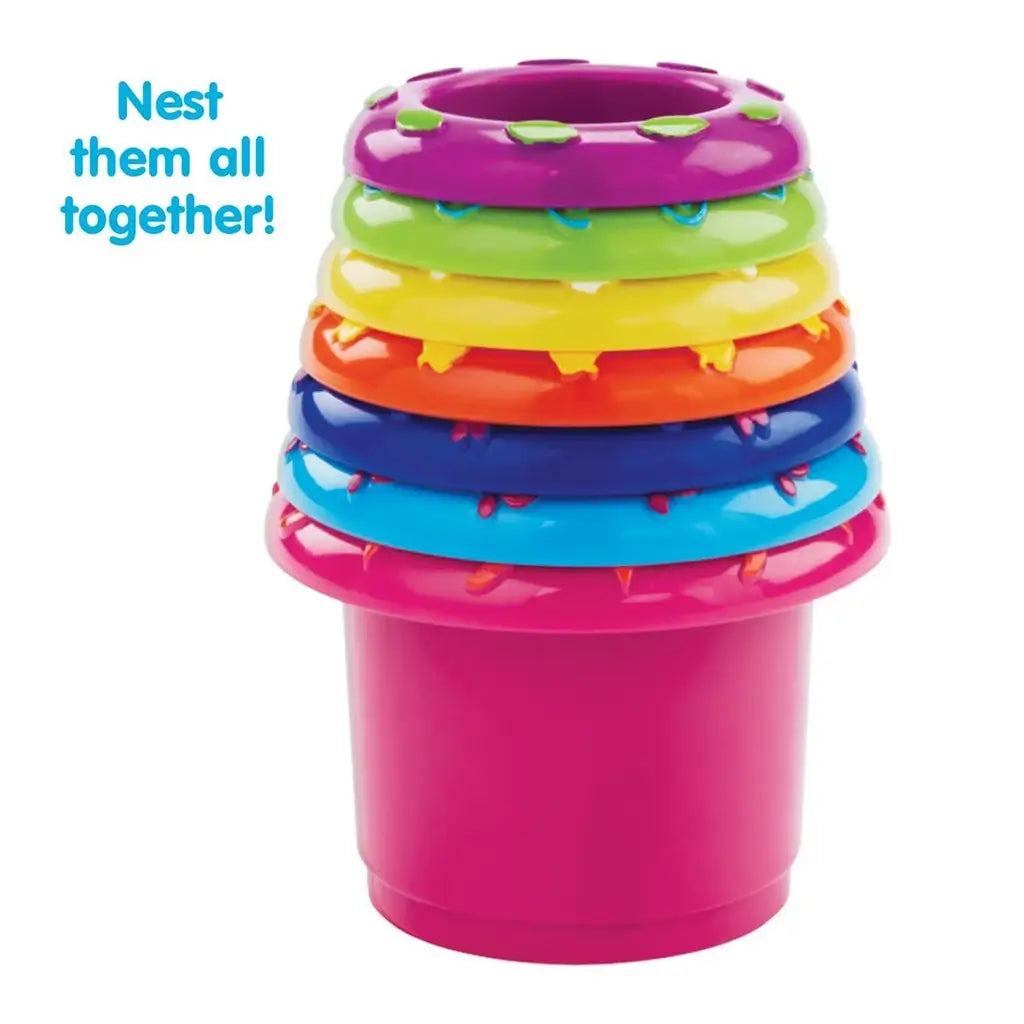 Colorful Kidoozie Stack 'n Nest Cups neatly nested together, with bright purple, green, yellow, orange, blue, and pink rims stacked for compact storage and easy toddler play.