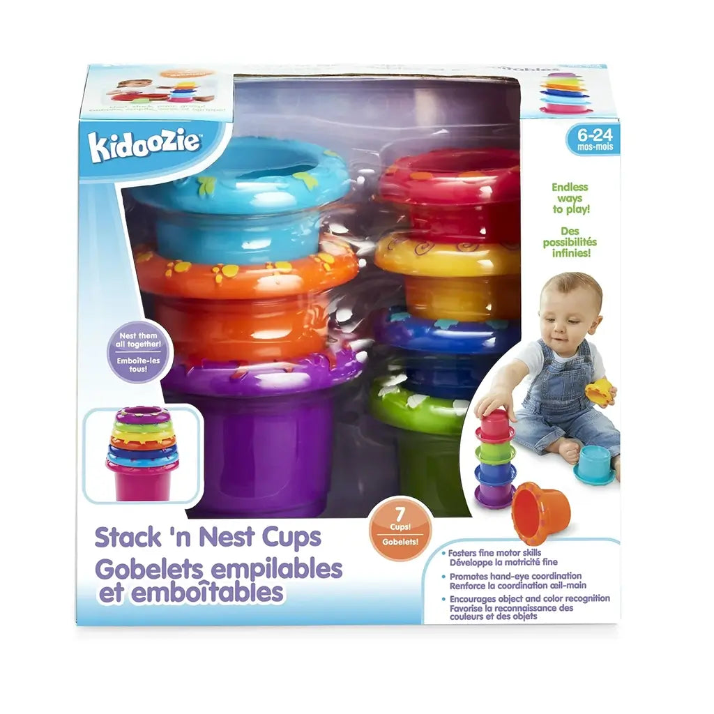 Kidoozie Stack 'n Nest Cups set in colorful plastic with seven stacking pieces shown in packaging, designed to build motor skills and encourage color recognition for toddlers aged 6–24 months.
