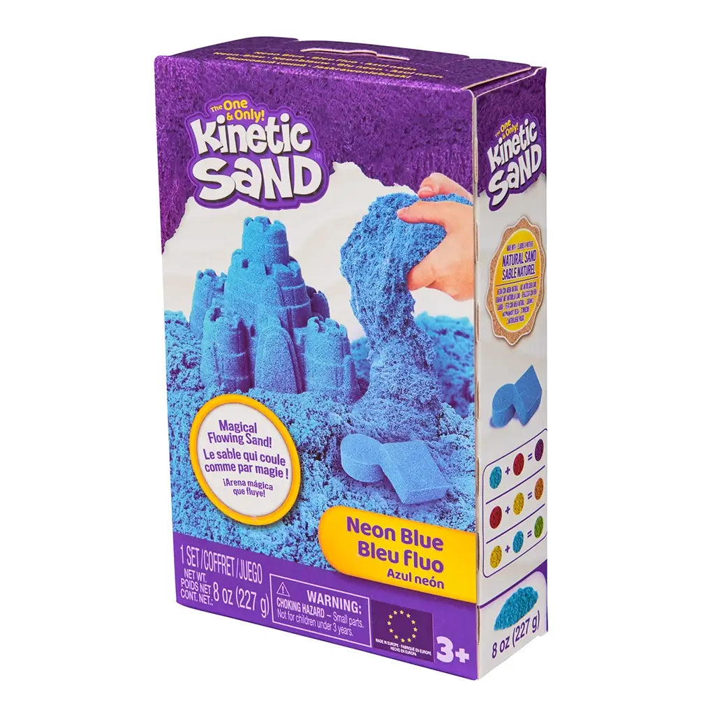 Kinetic Sand neon blue sand product box purple cardboard rectangular angled package displaying molded blue sand castle and pouring sand action for creative sensory play, on white background