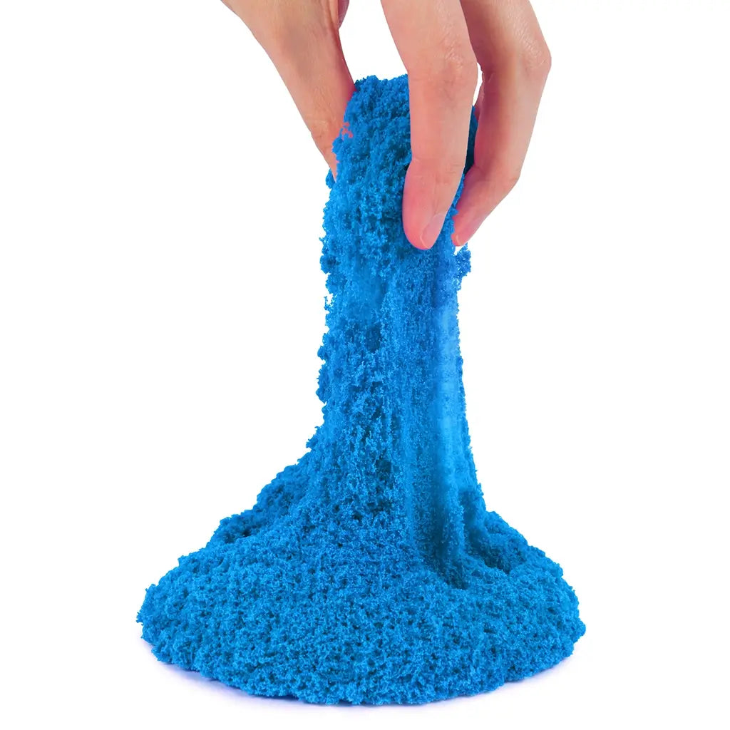 kinetic sand neon blue sand bright blue fine crumbly texture stretched by fingers into a soft flowing form for sensory play, displayed against a clean white background