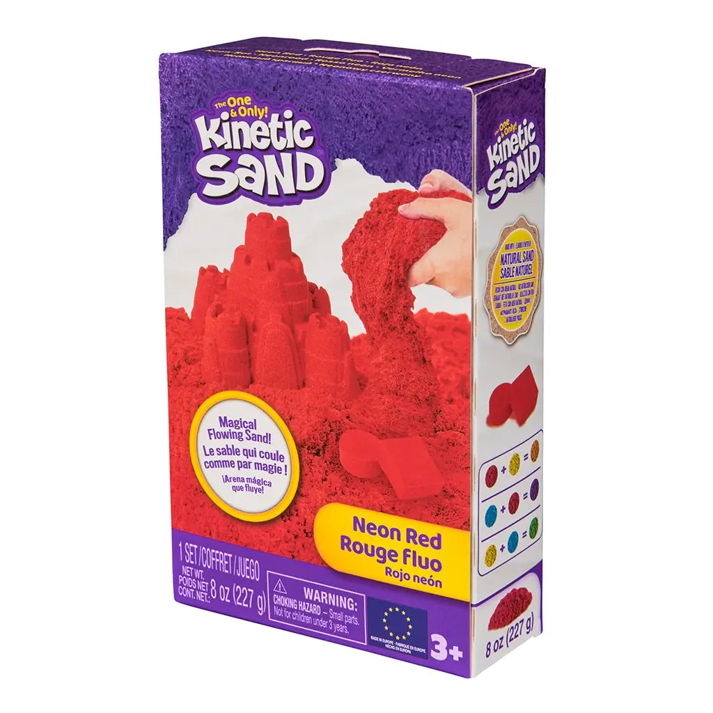 Kinetic Sand neon red sand product box purple cardboard rectangular package featuring red sand castle imagery for kids sensory play, shown angled against a neutral white background