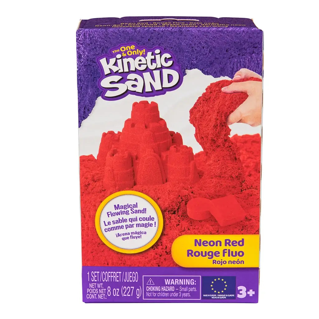 Kinetic Sand neon red sand product box purple cardboard rectangular front view showing red sand castle and flowing sand imagery for kids sensory play, on a clean white background