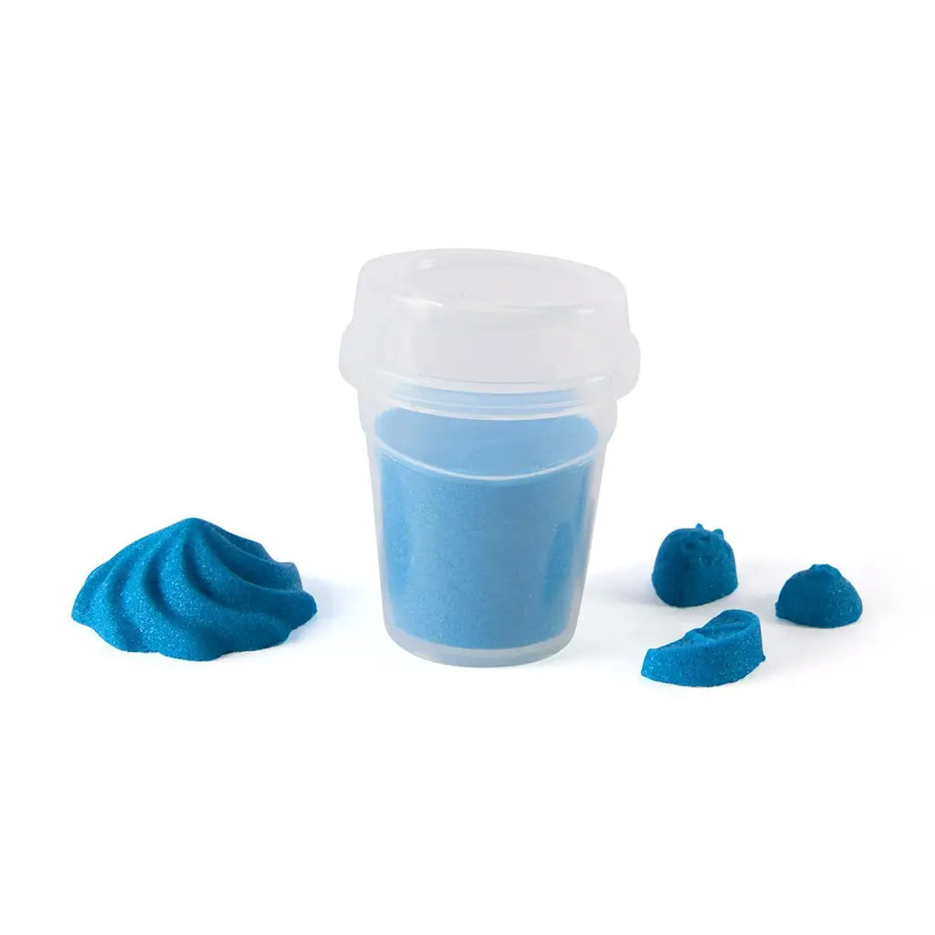 Kinetic sand container set in blue fine grain texture inside a clear plastic tub with lid, accompanied by small molded shapes, designed for sensory play on a minimal white background.