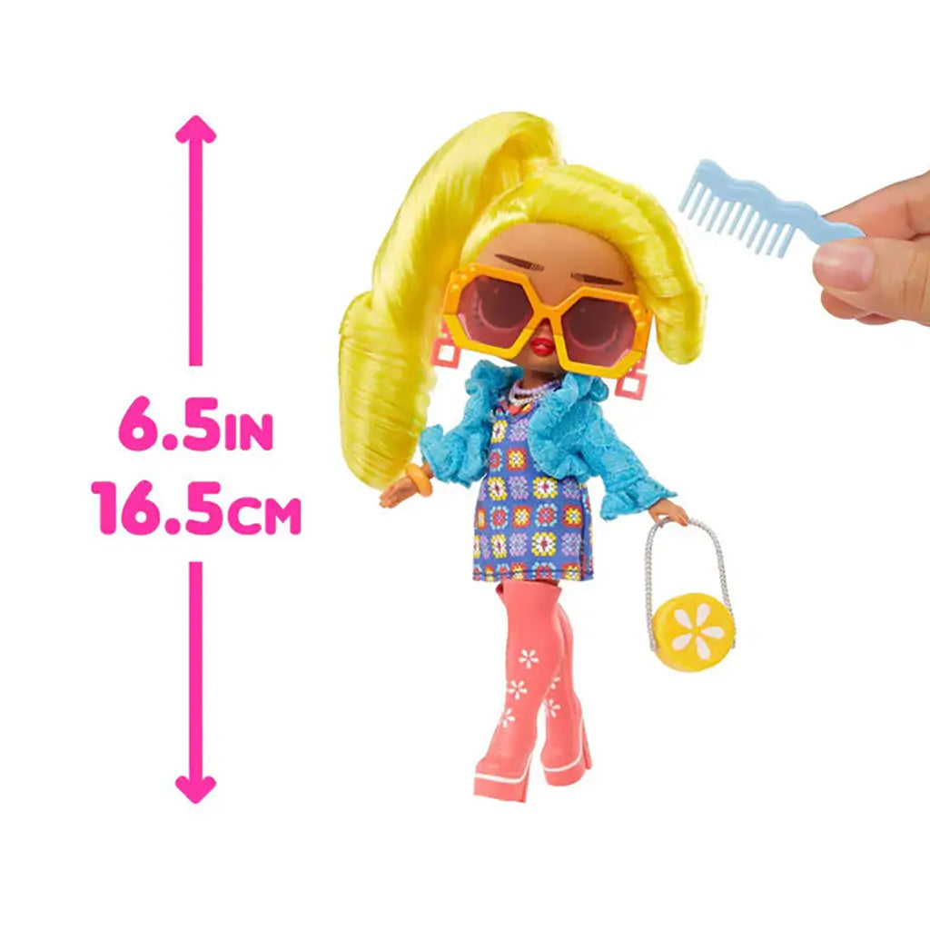 LOL Surprise Tweens Hana Groove doll with bright yellow ponytail, wearing pink boots and blue jacket, shown beside pink arrow marking 6.5 inches or 16.5 centimeters in height for size reference.