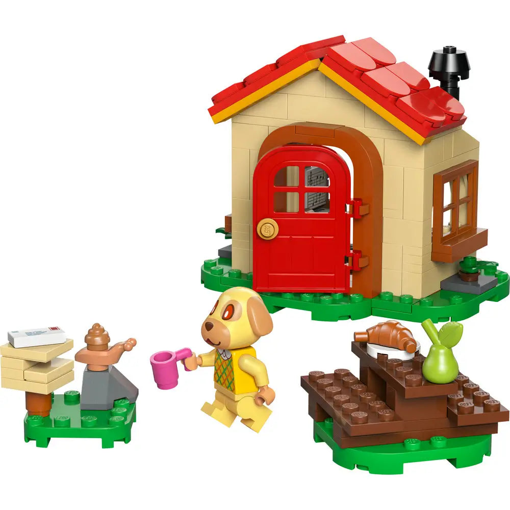 LEGO Animal Crossing Goldie's Cozy House playset features a tan cottage with a red roof, Goldie figure, mailbox and picnic table on a clean white background with detailed LEGO elements and realistic display presentation.