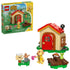 LEGO Animal Crossing Goldie's Cozy House playset features a tan cottage with a red roof, Goldie minifigure, mailbox and picnic table on a clean white background with detailed LEGO elements and realistic display presentation.